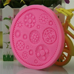 Pink round silicone mold featuring industrial gear and mechanical part patterns for cakes