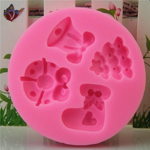 Pink silicone Christmas mold featuring bells, Xmas trees, and boots for DIY baking