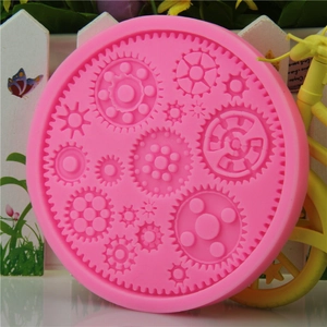 Pink silicone mold featuring various gear shapes for industrial theme cake decorating
