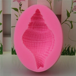 Pink seashell silicone mold for DIY fondant chocolate and resin crafts on floral background