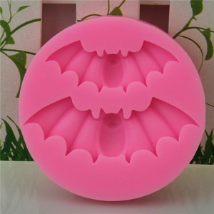 Pink silicone mold featuring two bat shapes for Halloween cake baking and DIY crafts
