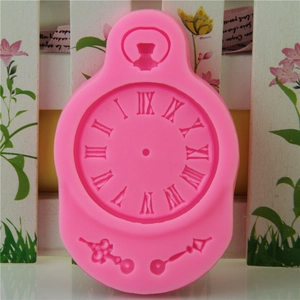 Pink silicone mold for fondant shaped like a vintage pocket watch with Roman numerals