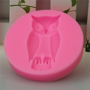 Pink circular silicone mold with detailed owl relief for DIY soap and fondant baking
