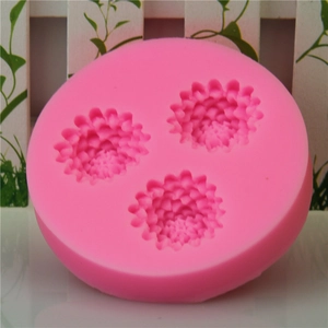 Pink silicone mold featuring three distinct pinecone flower shapes for cake decorating