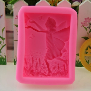 Detail of pink silicone mold featuring intricate fairy and butterfly embossed designs