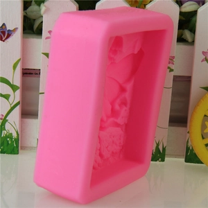 Detail view of pink rectangular silicone mold with embossed butterfly floral pattern