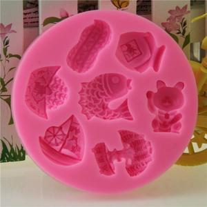 Pink silicone mold with fish and fortune cat patterns for Chinese New Year cake baking