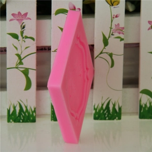 Pink diamond-shaped silicone mold with vintage patterns for cakes and chocolate making