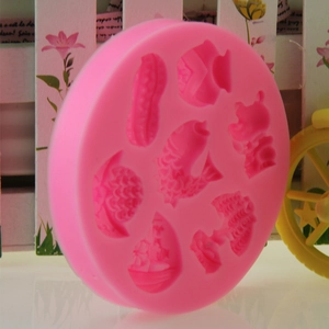 Pink silicone cake mold with lucky symbols like koi fish and peanuts for CNY baking