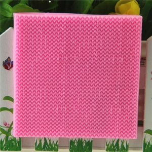 Pink silicone fondant mold with detailed sweater knit texture for cake decorating