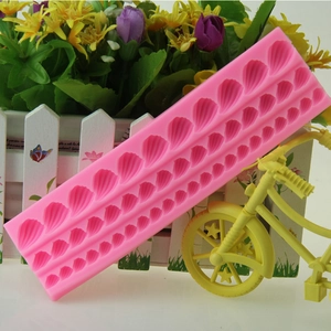 Pink silicone fondant mold with graduated leaf patterns for DIY chocolate cake decoration