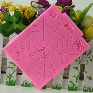 Pink silicone Halloween fondant mold with spider web and spider designs for cake decoration