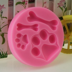 Pink silicone mold with bone and paw print shapes for DIY cake decorating and baking