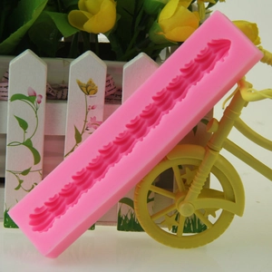 Pink silicone fondant mold with wavy lace pattern for creative cake decorating