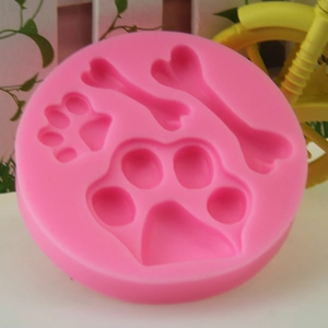Pink silicone mold featuring dog bone and paw print shapes for DIY baking and crafts