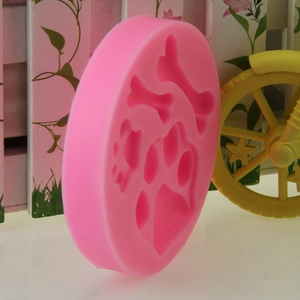 Pink silicone mold with dog paw and bone shapes for DIY baking and chocolate making
