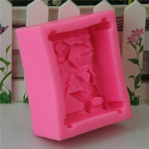 Pink silicone mold featuring butterfly and floral patterns for handmade soap and cakes