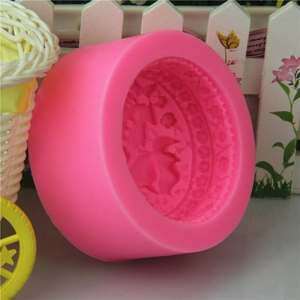 Pink silicone round mold with floral and leaf patterns for handmade soaps and baking
