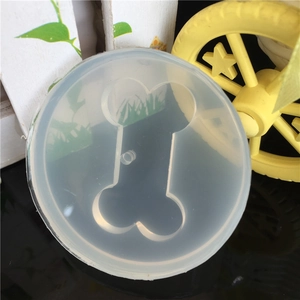 Silicone mold for bone shaped dog tags and DIY resin pendants on black background