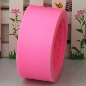 Pink silicone mold for handmade soap or fondant featuring detailed floral relief patterns