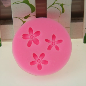 Pink silicone round mold featuring three mini five-petal flower cavities for DIY fondant