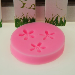 Pink silicone mold with three mini five-petal flower cavities for fondant and DIY crafts