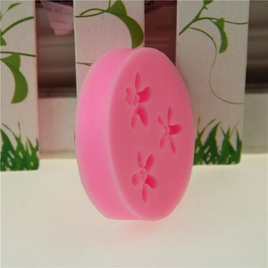 Pink silicone flower mold for fondant and chocolate cake decoration with orchid shapes