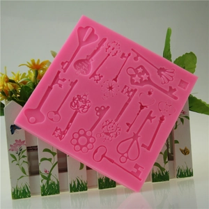 Pink steampunk silicone fondant mold featuring vintage key patterns for cake decorating