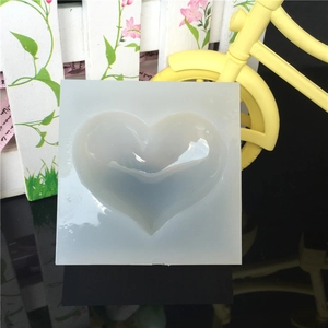 Translucent square silicone heart mold for DIY crystal resin or soap making on a black base
