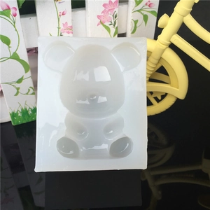 Sitting bear silicone mold for crystal resin and DIY crafts on a black reflective surface