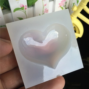 Handheld heart-shaped silicone mold with a glossy finish for DIY resin and clay crafts