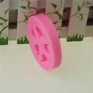 Pink round silicone mold with five small bird designs for fondant and cake decorating