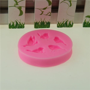 Pink silicone bird mold with five 3D relief bird shapes for cake decorating and DIY crafts