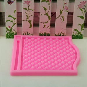 Close-up of pink grid textured silicone mold for DIY fondant cake lace decoration