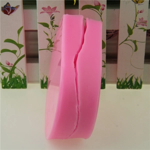 Detailed side view of pink silicone flower petal mold with vertical slit for easy release