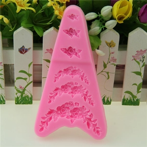 Pink silicone fondant mold featuring six classic rose flower designs for cake decorating