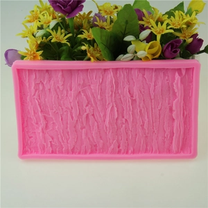 Pink silicone mold for cake decorating featuring a realistic tree bark texture pattern