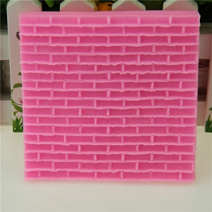 Pink silicone mold featuring realistic castle brick wall texture for fondant cake decoration