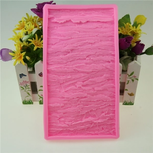 Pink silicone mold featuring tree bark texture for DIY cake decorating and baking