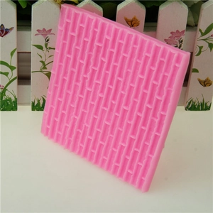 Pink silicone fondant mold with rectangular brick wall pattern for cake decoration