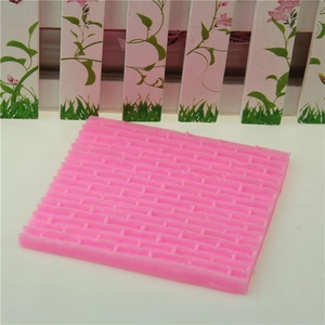 Pink silicone mold featuring realistic castle brick wall texture for fondant cake decoration