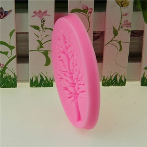 Pink silicone mold featuring intricate tree branch patterns for fondant and cake decorating