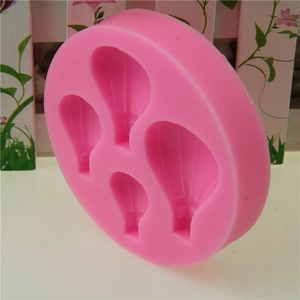 Pink silicone mold with four hot air balloon shapes for fondant cake decorating and baking