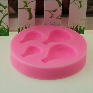 Pink silicone mold featuring four hot air balloon cavities for cake decorating and DIY baking