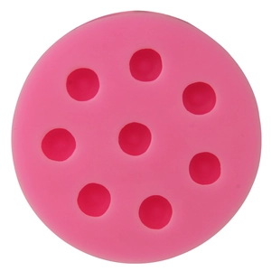 Detailed macro view of 8-cavity round pink silicone mold for cake and chocolate decorating