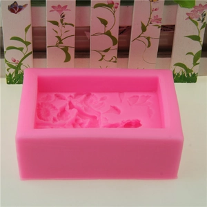 Pink rectangular silicone soap mold with intricate floral fairy patterns for DIY crafts