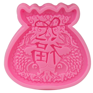 Close-up of pink silicone fondant mold with traditional Chinese lucky bag and koi fish design