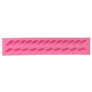 Detailed macro of pink silicone cake mold with twisted rope weave pattern for DIY baking