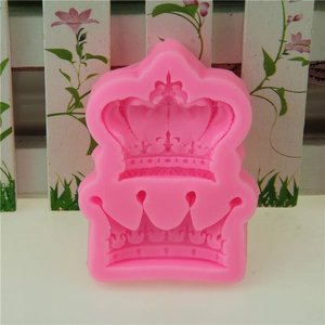 Pink silicone crown mold for DIY fondant and chocolate baking on a floral background