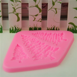 Pink silicone fondant mold featuring three different sizes of Christmas tree shapes for baking